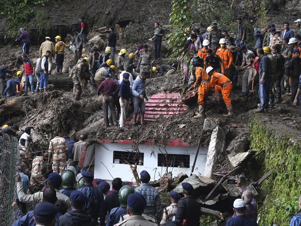 Rescuers search for people after a landslide in India in August that was caused by torrential rains. Climate-driven disasters are particularly destructive in places that are not wealthy, and such disasters can set off cycles of destruction, debt and further vulnerability.