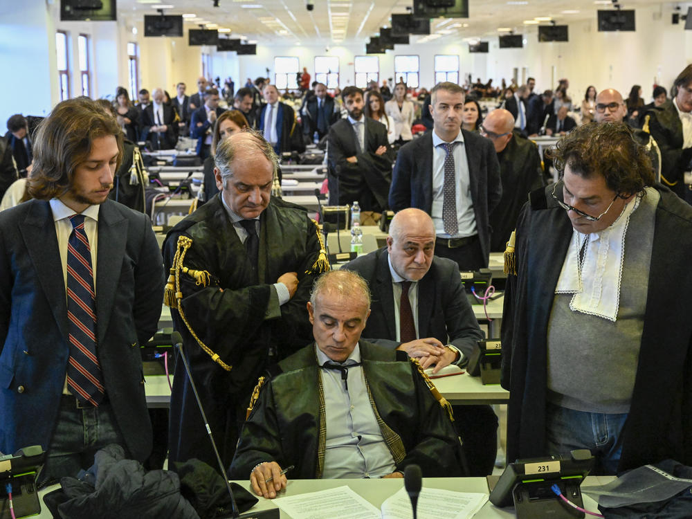 Officials listen as judges read the verdicts of a maxi-trial of hundreds of people accused of membership in Italy's 'ndrangheta organized crime syndicate.