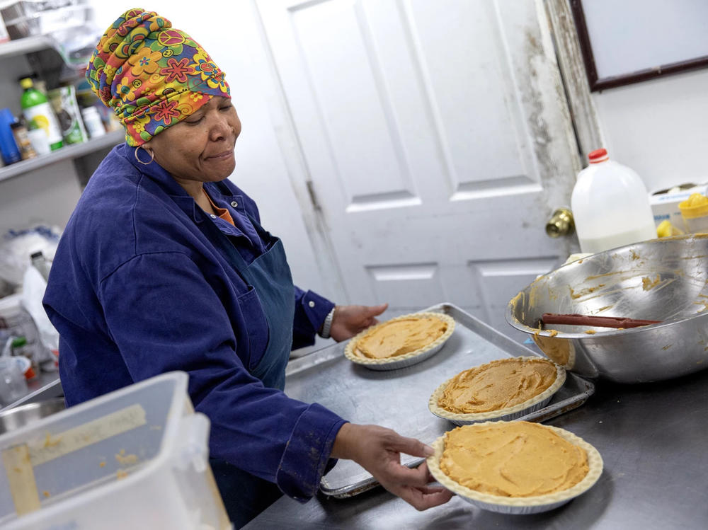 Pastry chef Carla Jones loads a trio of sweet potato pies onto a tray destined for the oven on Nov. 15 at Ol' Henry, a restaurant in Berkeley, Mo.