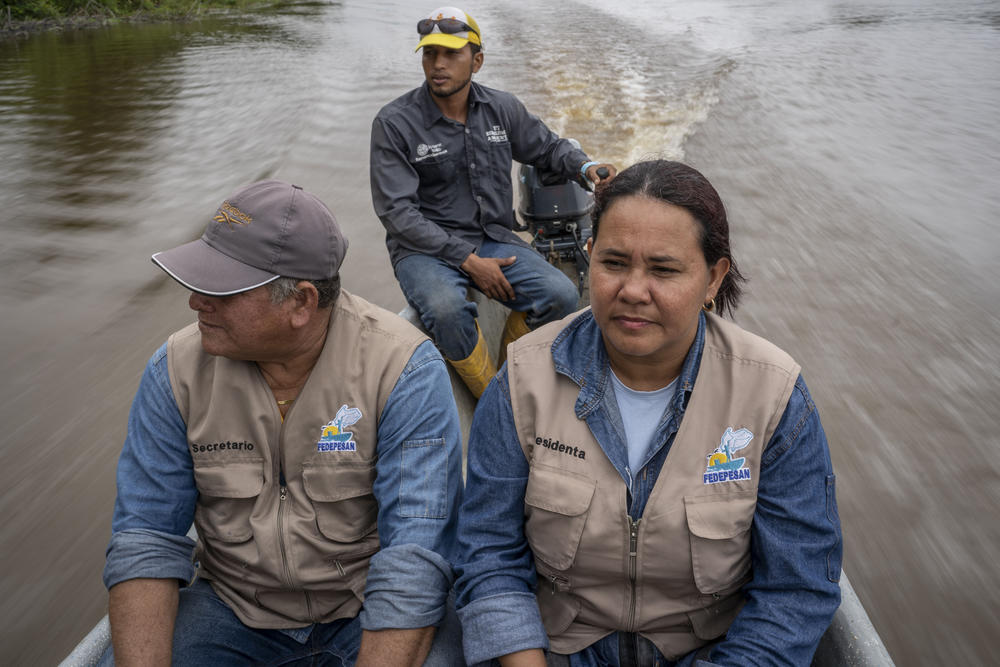 Oswaldo Beltrán (left) said armed intruders burst into his home while he was gone, tied up his wife and threatened to chops his sons fingers off unless he told them of his father's whereabouts. But he continues to work with Velásquez in the fishers association.