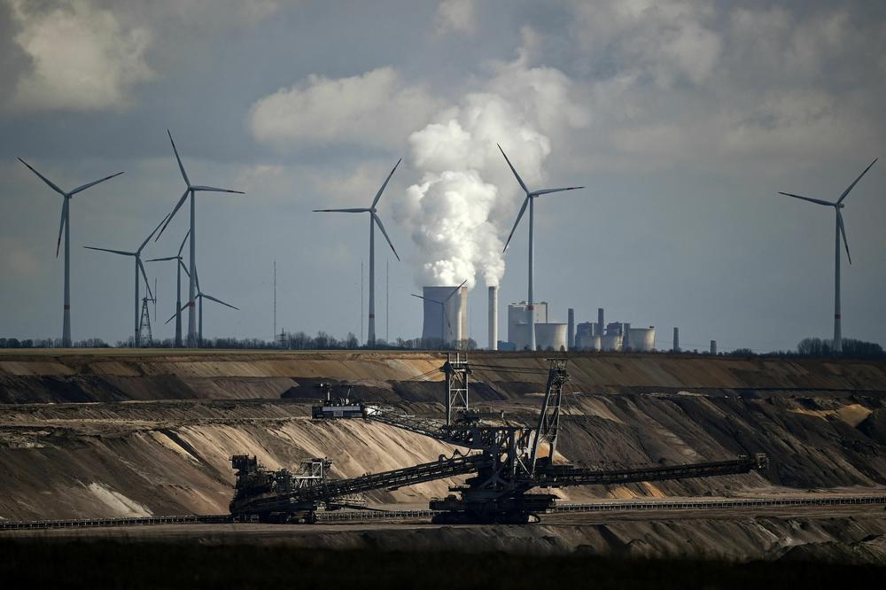 Wind turbines stand near a mining project and a coal-fired power plant in Germany.