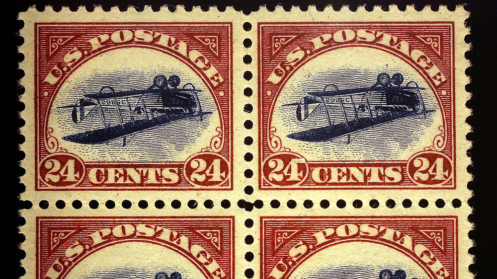 An enlarged replica of a block of four rare United States airmail error stamps, known as the Inverted Jenny plate block.