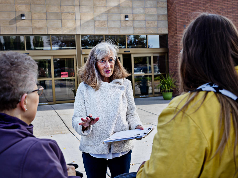 Parents Against Bad Books co-founder Carolyn Harrison (center) talks with people last month outside the public library in Idaho Falls, Idaho, about what she considers obscene books on the shelves.