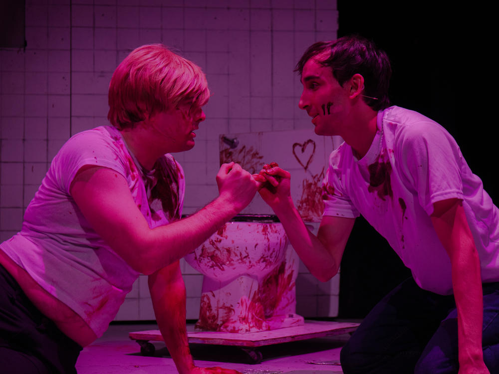 Andrew Caira (left) and Adam Parbhoo (right) star in a performance of <em>Saw the Musical: The Unauthorized Parody of Saw</em> at Manhattan's AMT theater.