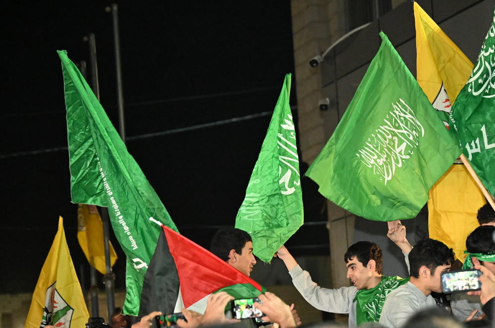 In Beutunia in West Bank, released prisoners (in gray) were hoisted on shoulders and danced around to songs and joy on Nov. 24, 2023.