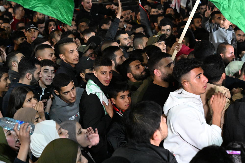 Palestinians cheer for the return of the prisoners in Beitunia, West Bank on Nov. 24, 2023.