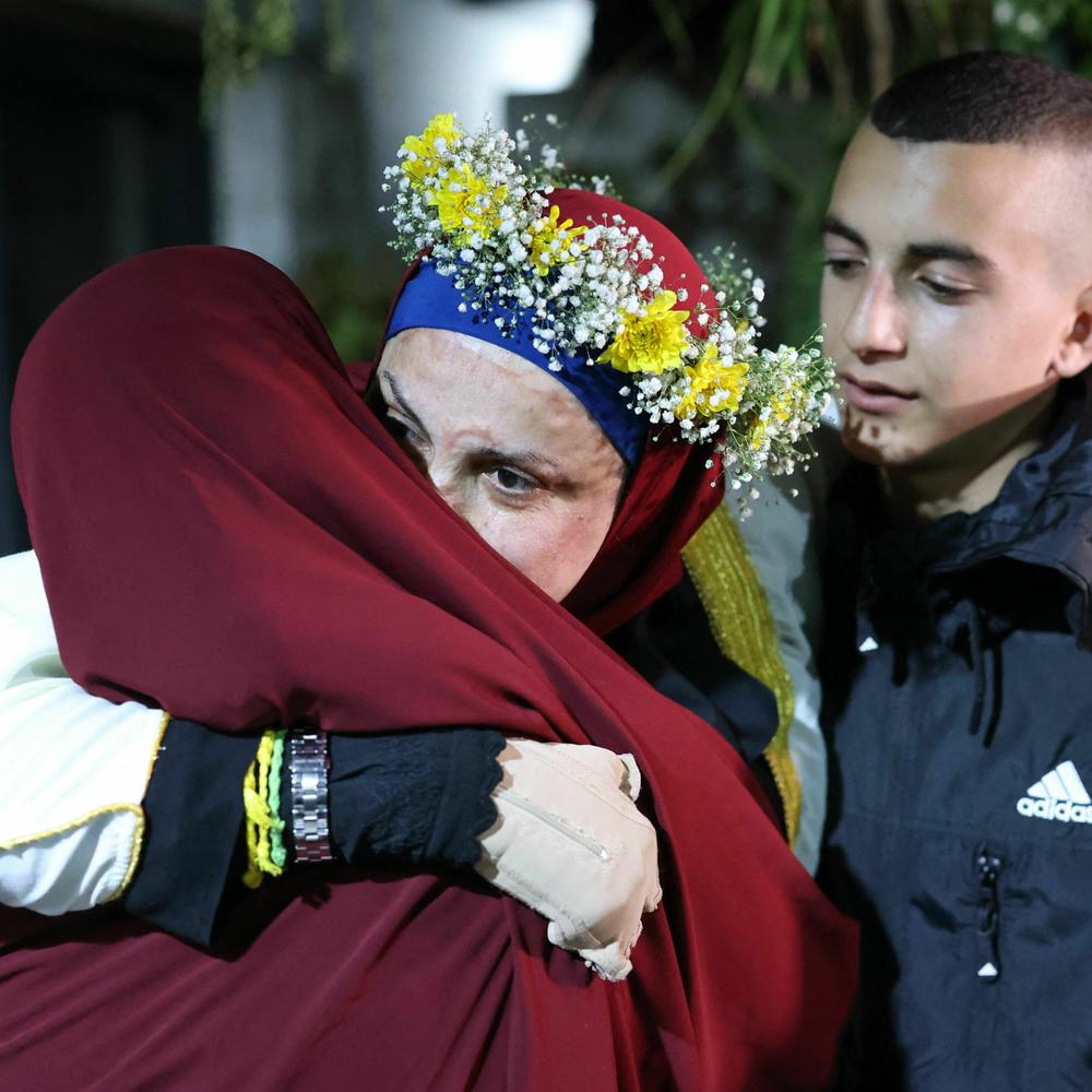 Relatives of prominent Palestinian prisoner Israa Jaabis, center, welcome her at her home in East Jerusalem early Sunday after detainees were released from Israeli jails in exchange for hostages released by Hamas.