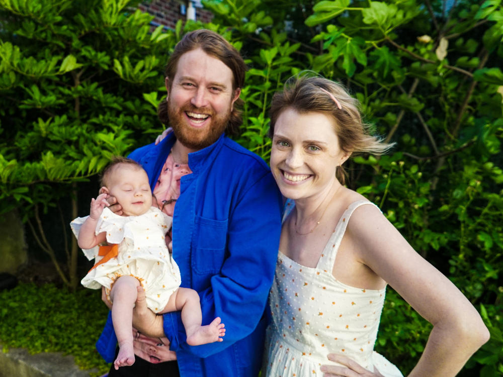 Casey McIntyre (right) Andrew Gregory (center) and their daughter, Grace.