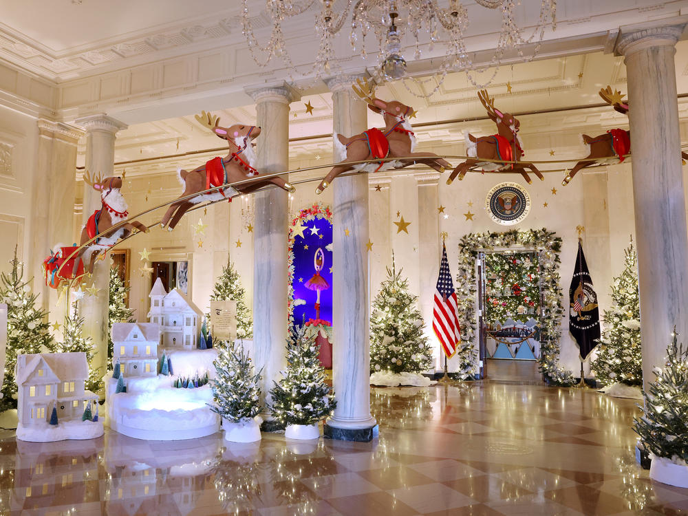 Santa Claus in his sleigh and a team of reindeer fly through the columns of the Entrance Hall of the White House. The theme for this year's White House decorations is 