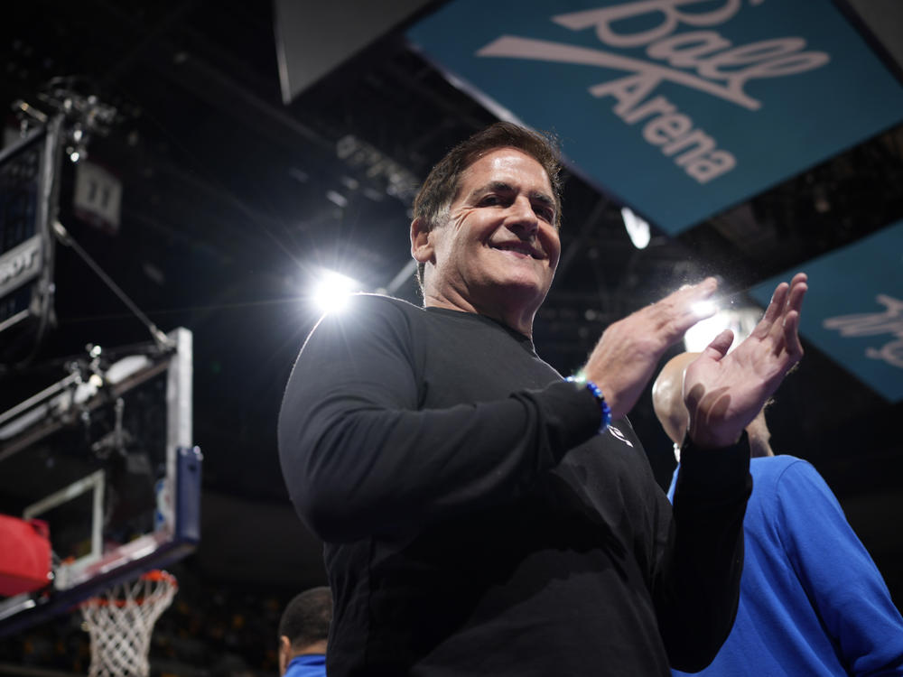 Dallas Mavericks owner Mark Cuban applauds as Mavericks are introduced for an NBA against the Denver Nuggets on Friday, Nov. 3, 2023, in Denver. Cuban is reportedly in talks to sell his stake in the team to the Miriam Adelson, widow of Las Vegas casino magnate Sheldon Adelson.
