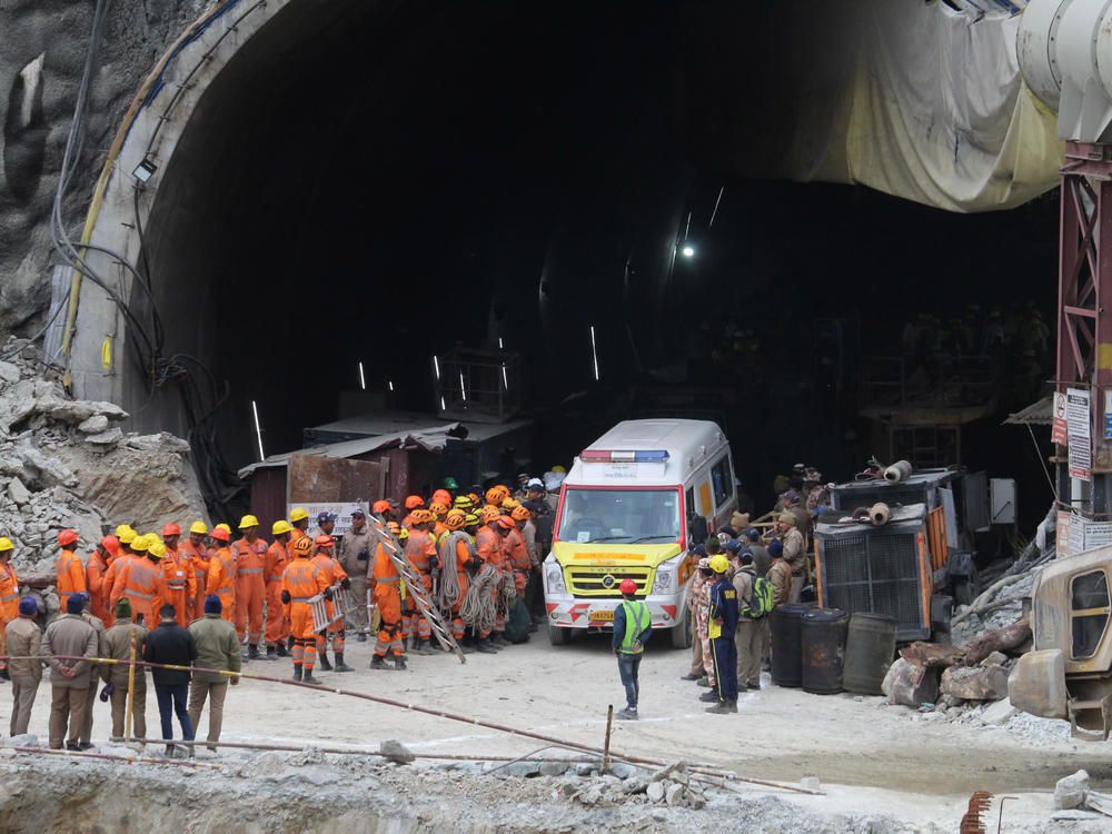 An ambulance waits to carry workers from the site of an under-construction road tunnel that collapsed in Silkyara in the Indian state of Uttarakhand.