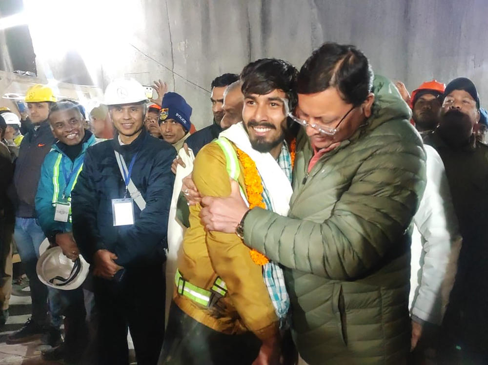 Pushkar Singh Dhami (right), chief minister of Uttarakhand state, greeting a worker rescued from the site of the collapsed tunnel.
