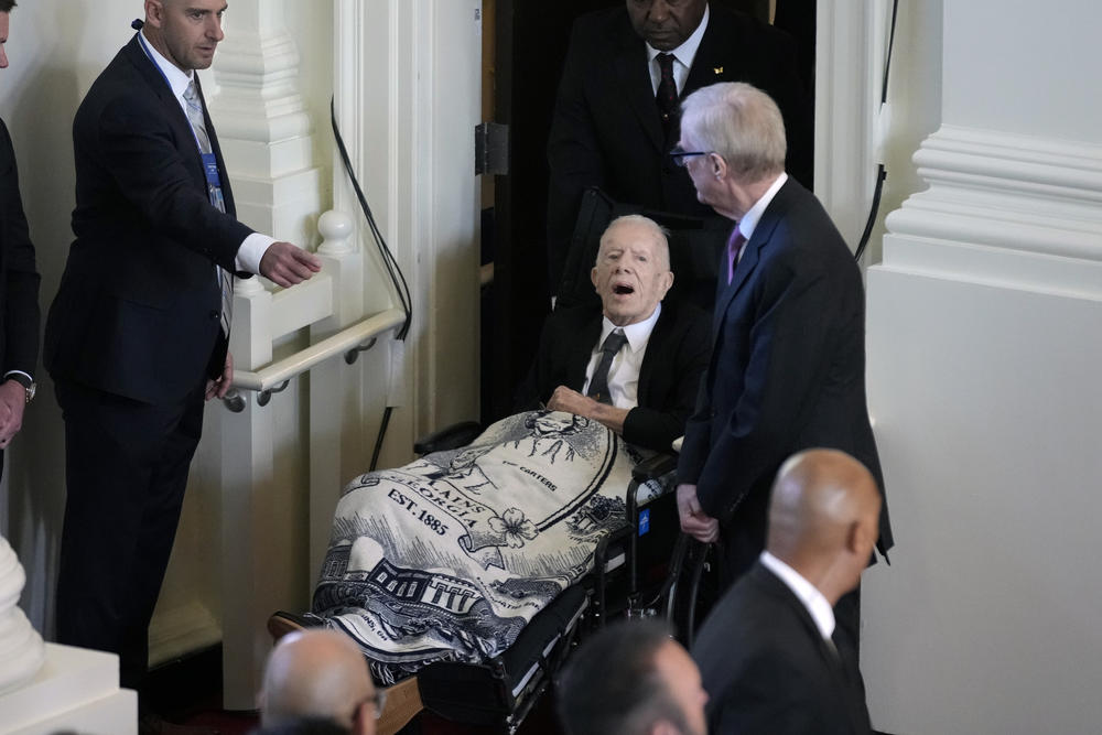 Former President Jimmy Carter, arrives to attend a tribute service for his wife and former first lady Rosalynn Carter, at Glenn Memorial Church, Tuesday, Nov. 28, 2023, in Atlanta.
