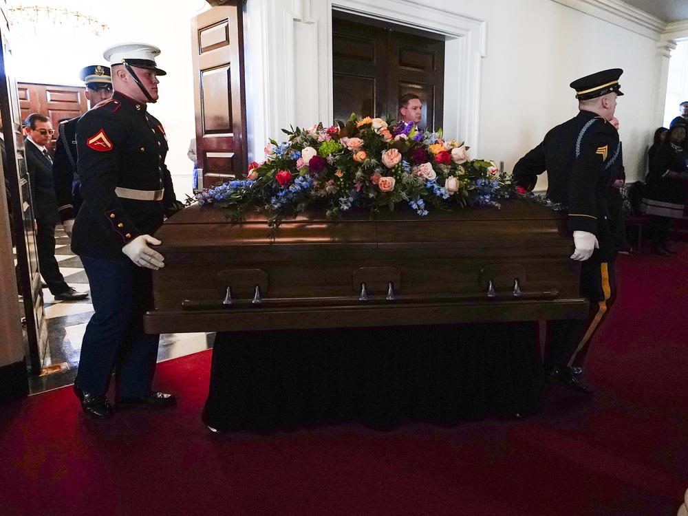 An Armed Forces body bear teams moves the casket for former first lady Rosalynn Carter into Glenn Memorial Church at Emory University for a tribute service on Tuesday, Nov. 28, 2023, in Atlanta.