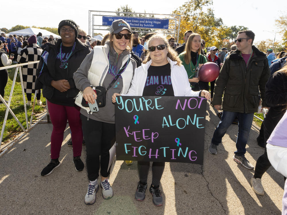 Participants walk in support and in memory of those lost, during American Foundation for Suicide Prevention Out of the Darkness Chicagoland Walk at Montrose Harbor on October 21, 2023 in Chicago, Illinois.