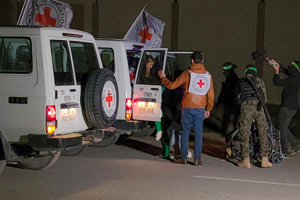 Hamas hands over 11 Israeli hostages to the International Committee of the Red Cross in Gaza City, Nov. 27.
