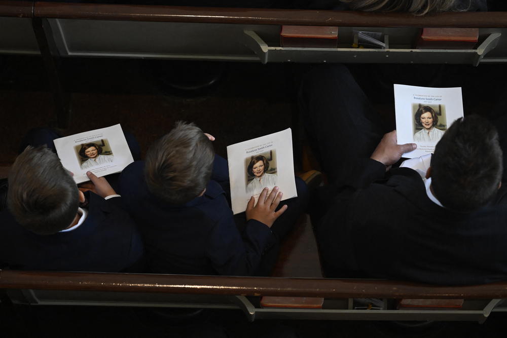 Guests hold programs during a tribute service for former first lady Rosalynn Carter at Glenn Memorial Church at Emory University in Atlanta, Ga., on Nov. 28, 2023.