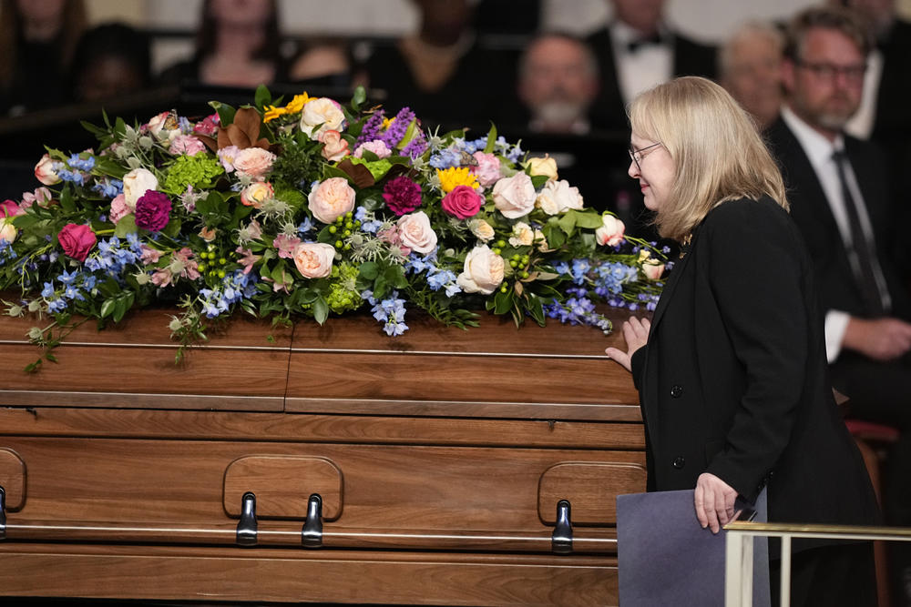 Amy Carter, daughter of former President Jimmy Carter and Rosalynn Carter, touches the casket after speaking at her mother's tribute service at Glenn Memorial United Methodist Church at Emory University on Nov. 28, 2023 in Atlanta, Ga.
