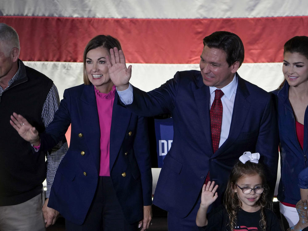 Iowa Gov. Kim Reynolds, second from left, joins Republican presidential candidate Florida Gov. Ron DeSantis on stage during a rally on Nov. 6 in Des Moines, Iowa.