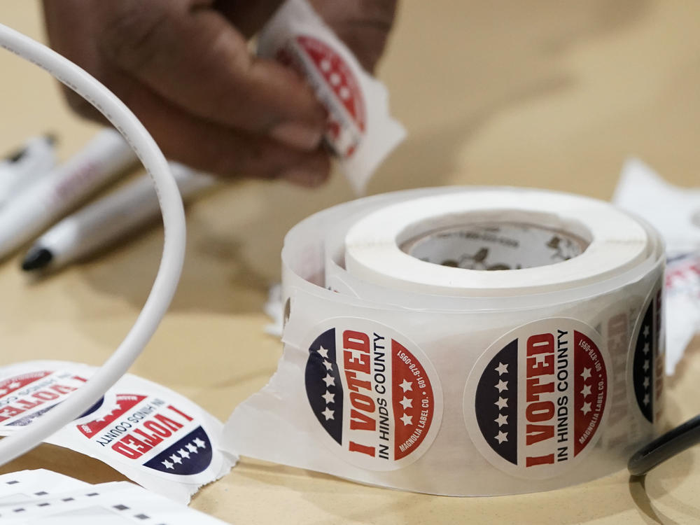 A precinct worker reaches for more 