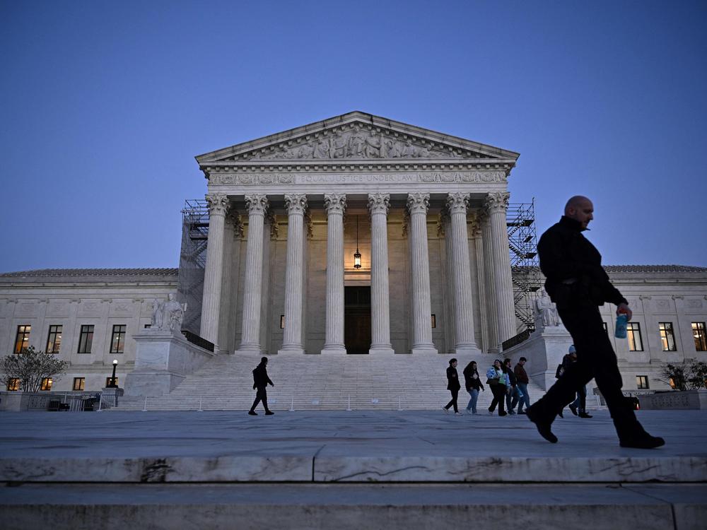 People walk past the U.S. Supreme Court in Washington, D.C., earlier this month.