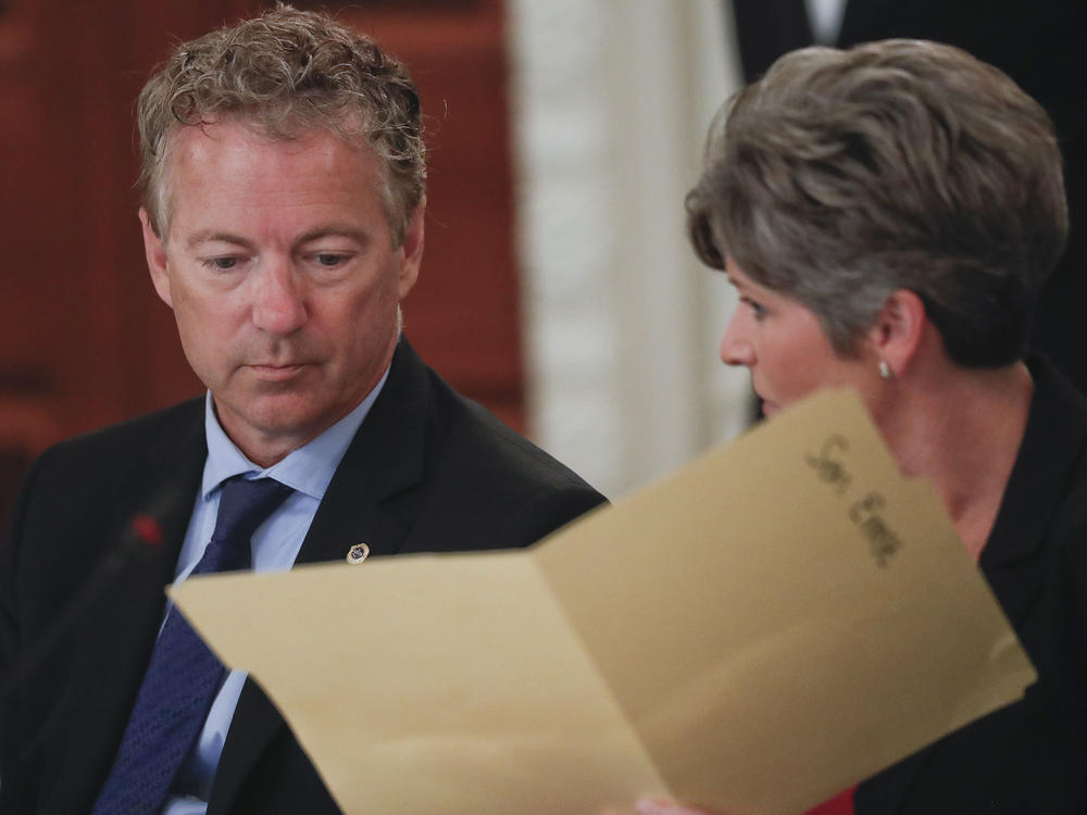 Sen. Rand Paul, R-Ky., performed the Heimlich maneuver on Sen. Joni Ernst, R-Iowa as she was choking Thursday during a closed-door GOP lunch. Here, Paul and Ernst look over a folder provided to them by the White House, during a luncheon in 2017 in the State Dinning Room of the White House.