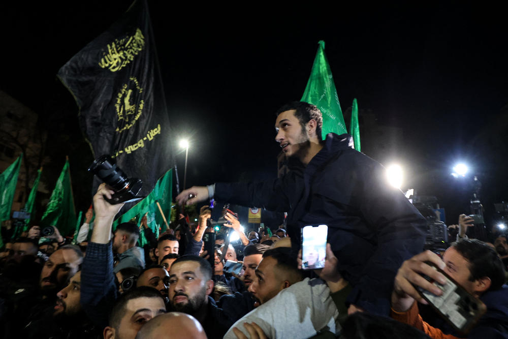 Newly released Palestinian prisoners are surrounded by supporters in Ramallah in the occupied West Bank early Thursday.