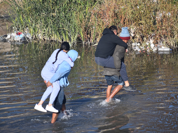 Migrants cross the Rio Grande from Mexico near El Paso, Texas. A new law makes illegal entry into Texas from a foreign country a state crime. It also authorizes a state judge to order someone to return to Mexico after their arrest.