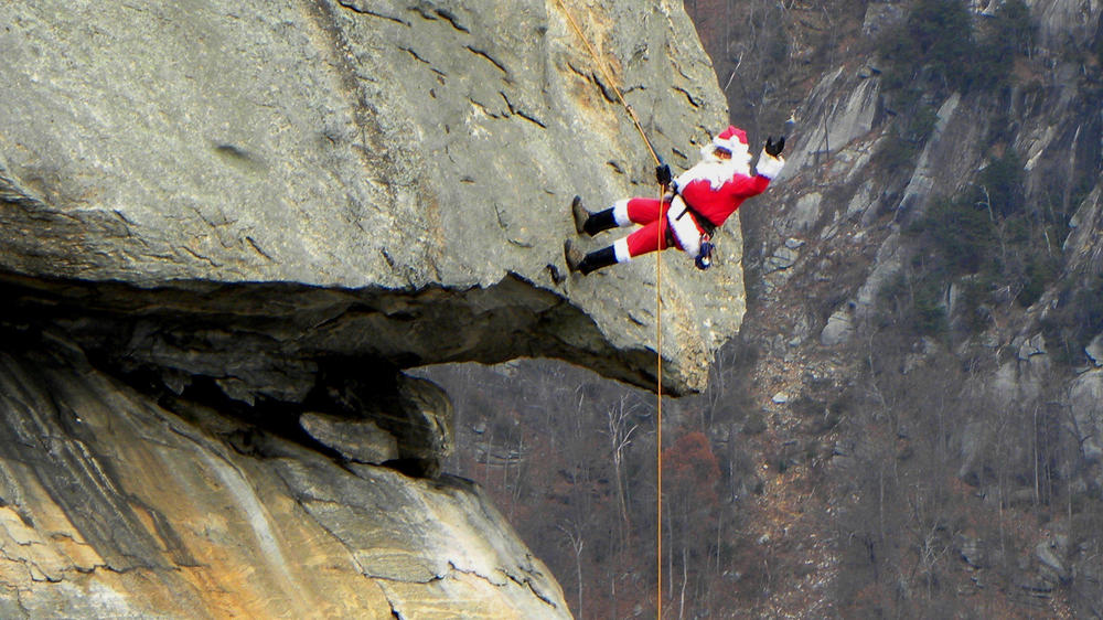 Santa rappels down a natural chimney several times each December at Chimney Rock State Park, near Asheville, North Carolina.