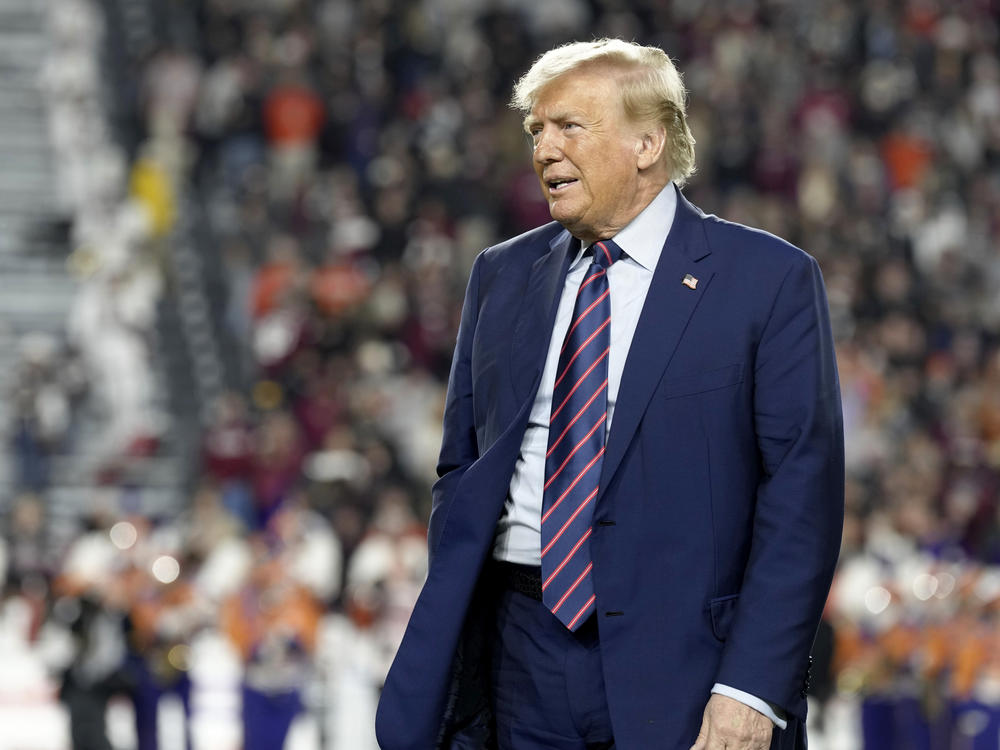 Republican presidential candidate and former President Donald Trump stands on the field during halftime in an NCAA college football game between the University of South Carolina and Clemson Saturday, Nov. 25, 2023, in Columbia, S.C.