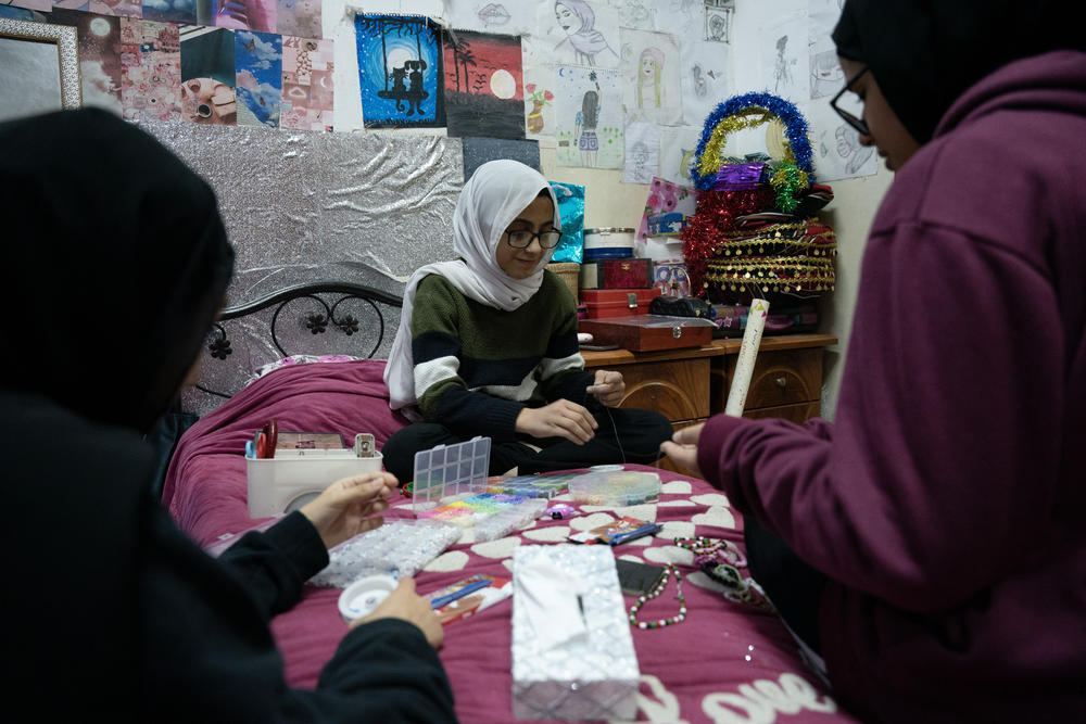 Aseel Shahada's cousins and sister prepare bracelets for her possible return this week in her bedroom in Qalandiya refugee camp in Ramallah, West Bank, on Nov. 22.