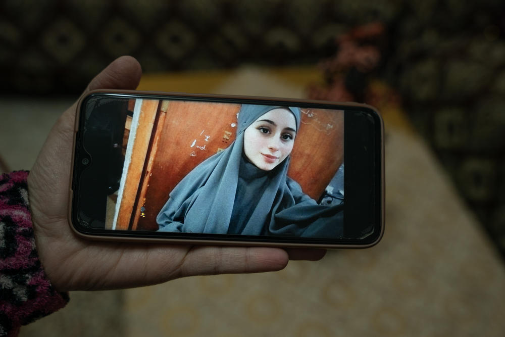 Rimah Shahada holds an image of her daughter Aseel on her phone in Qalandiya refugee camp in Ramallah, West Bank Nov. 22.
