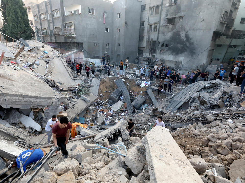 Palestinians search the destroyed annex of the Church of Saint Porphyrius, damaged in a strike on Gaza City on Oct. 20.