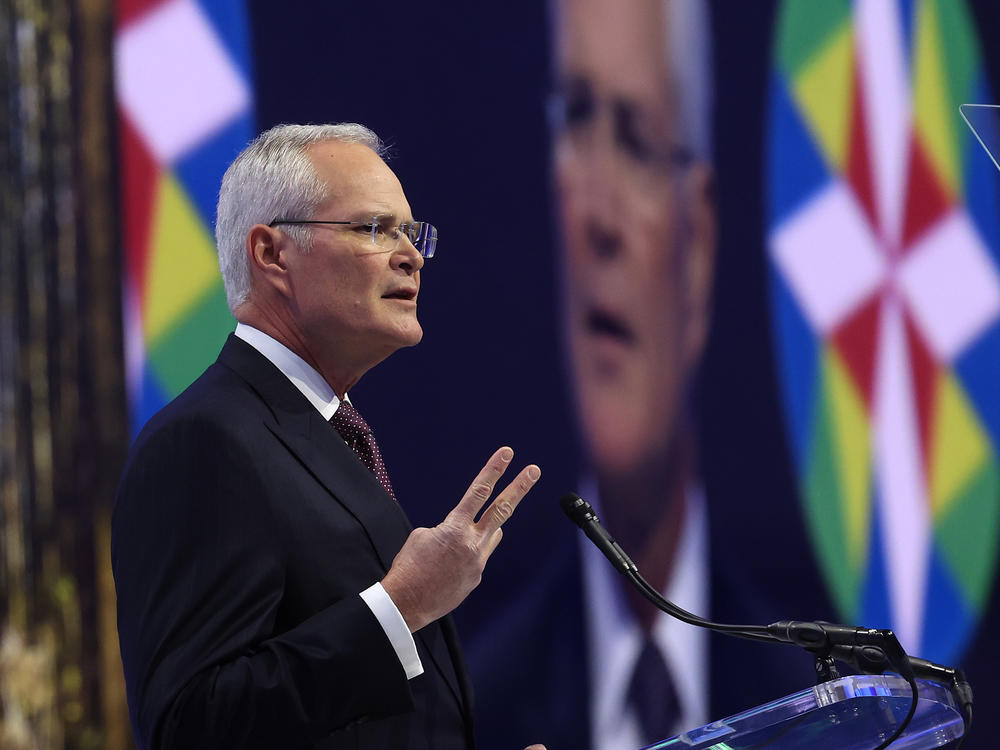 ExxonMobil CEO Darren Woods gives a speech in November 2023. In his remarks, Woods talked about fossil fuels as 
