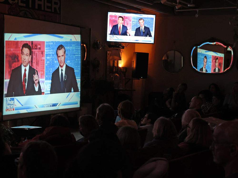 People gather in San Francisco to watch a debate on Fox News between California Gov. Gavin Newsom and Florida Gov. Ron DeSantis.