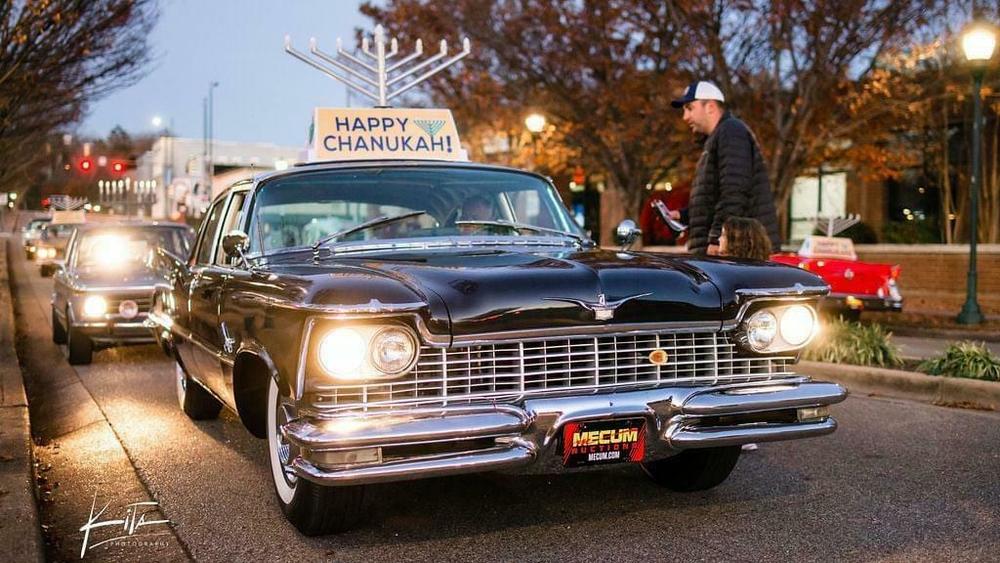 The Chattanooga menorah-topped car parade, pictured in 2021, has become something of a vintage car show over the years.