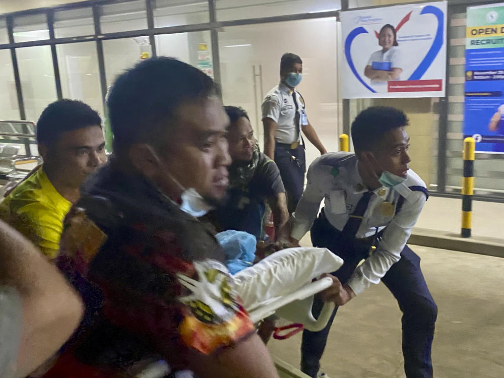 Patients at Manuel J. Santos Hospital in Butuan City, southern Philippines, are evacuated after an earthquake, Saturday evening, Dec. 2, 2023. A powerful earthquake with a preliminary magnitude of 7.6 struck Saturday off the southern Philippine coast, prompting many villagers to flee their homes in panic after Philippine authorities issued a tsunami warning.