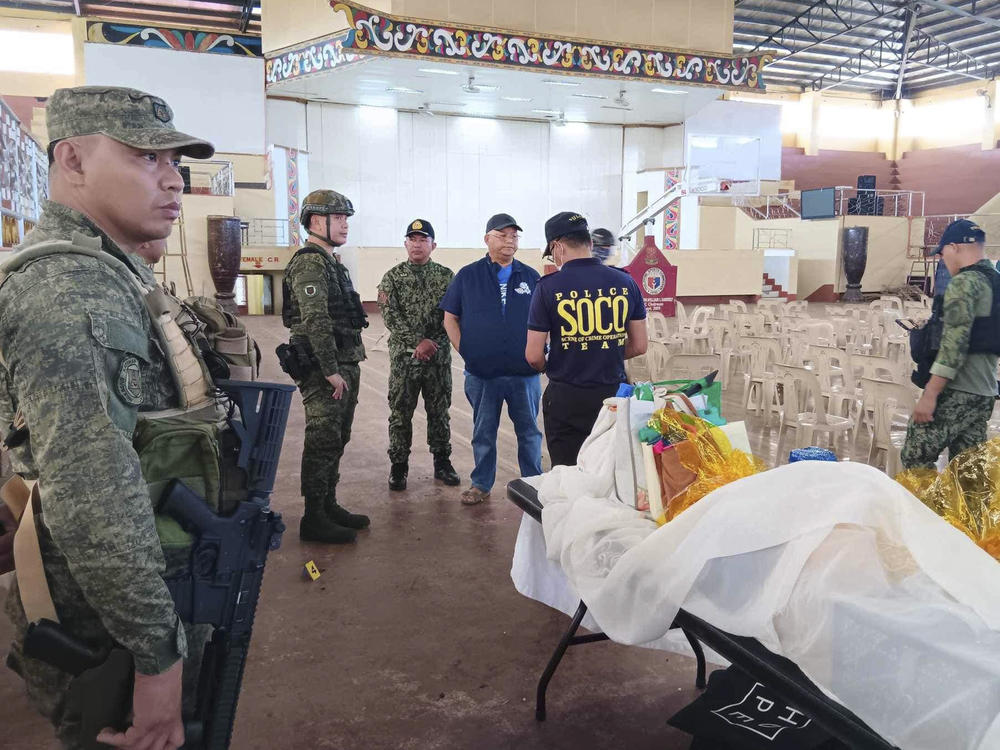 In this handout photo provided by the Provincial Government of Lanao Del Sur - Public Information Office, law enforcers conduct an investigation at the site of an explosion in Marawi city, southern Philippines on Sunday Dec. 3, 2023.