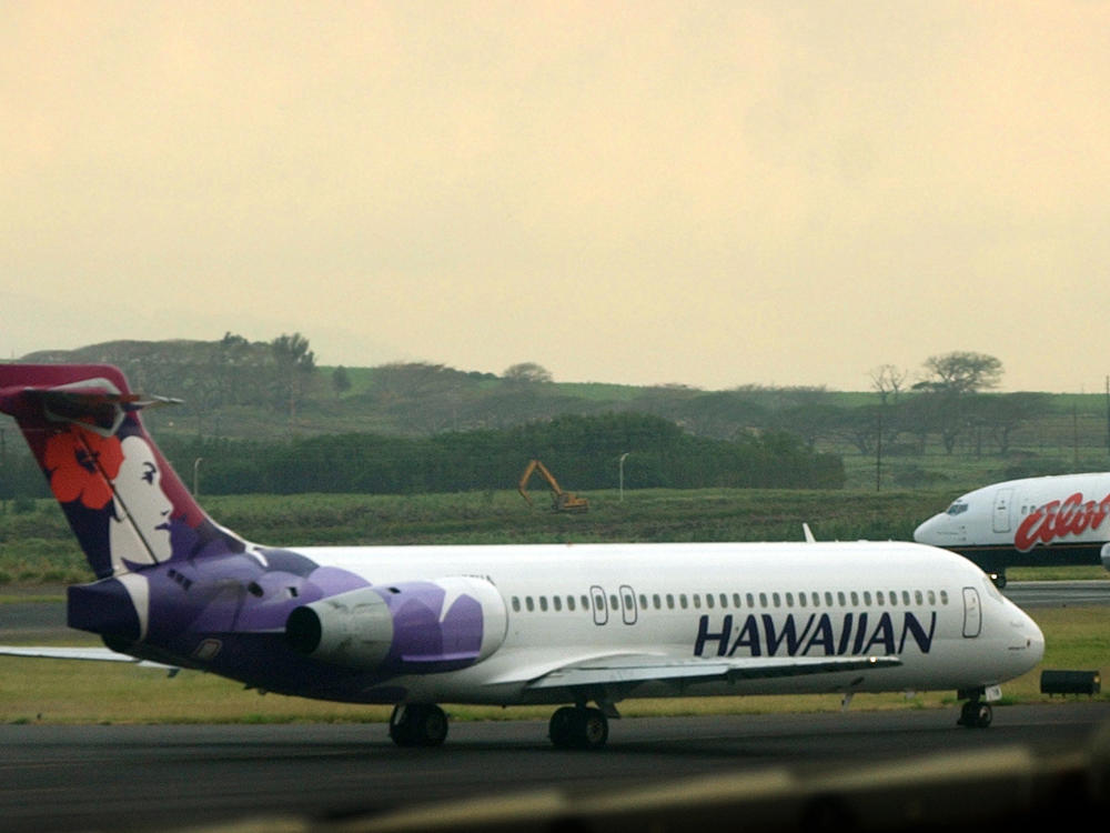 An Hawaiian Airlines plane taxis for position at Kahalui, Hawaii, on the island of Maui, March 24, 2005. Alaska Air Group said Sunday that it agreed to buy Hawaiian Airlines.
