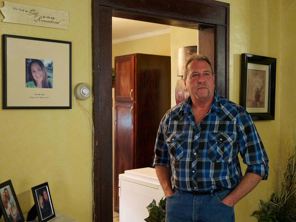 Ernie Haynes stands next to a memorial for his daughter, Jennifer, at his home in Risingsun, Ohio. Following her drug overdose death in 2017, he was charged with abduction after trying to gain custody of his grandchildren. The action sparked a five-year legal battle to clear his name.
