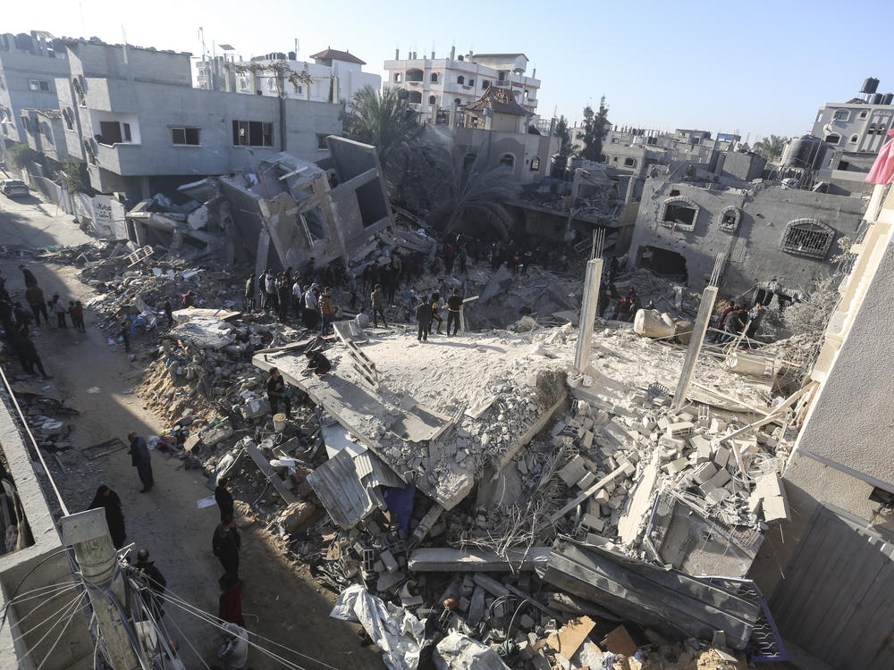Palestinians look for survivors of the Israeli bombardment of the Gaza Strip in Rafah, Sunday, Dec. 3, 2023. (AP Photo/Hatem Ali)