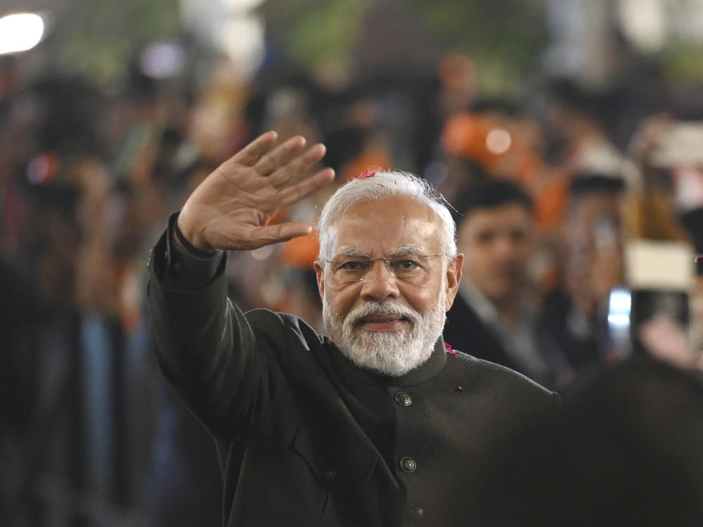 Indian Prime Minister Narendra Modi greets party worker during celebrations following Bharatiya Janata Party's victory in the state elections at the BJP headquarters in New Delhi, India, Sunday, Dec. 3, 2023.