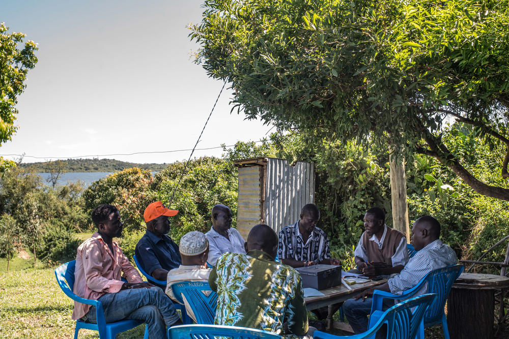 A meeting of another rotating savings club in the same village, this one founded by Denis Otieno (third from the right). People who were promised the monthly income grants for 12 years used such clubs at an astonishing rate – contributing nearly 70% more money than those in the control group that got no aid.