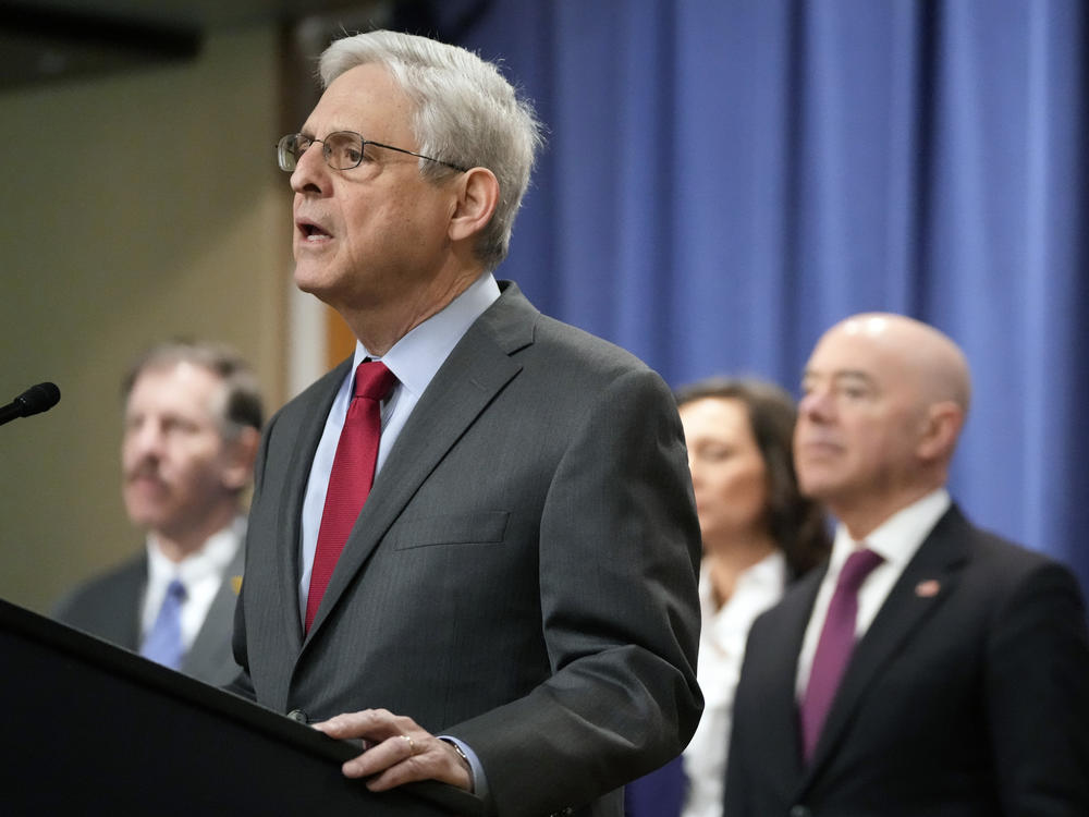 Attorney General Merrick Garland speaks with reporters during a news conference at the Department of Justice on Wednesday as Secretary of Homeland Security Alejandro Mayorkas, right, looks on.