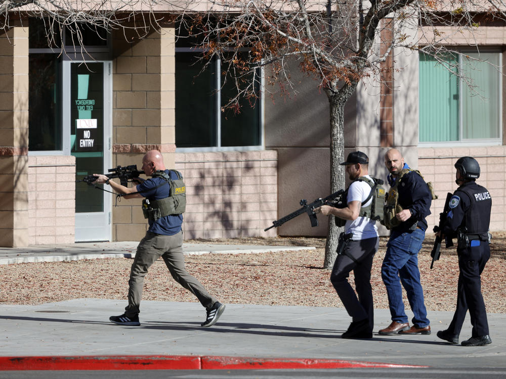 Law enforcement officers head into the University of Nevada, Las Vegas, campus after reports of an active shooter, Wednesday, Dec. 6, 2023, in Las Vegas.
