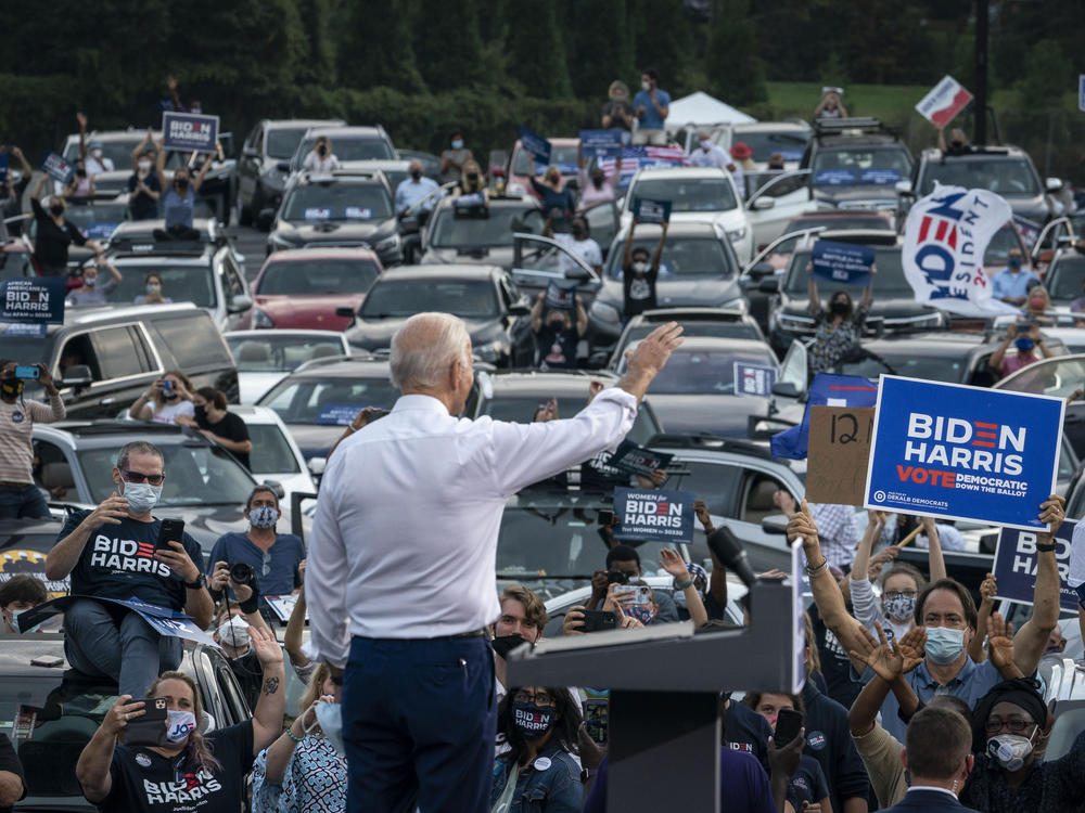 Then presidential candidate Joe Biden waves to supporters as he finishes speaking during a drive-in campaign rally in Georgia in 2020.