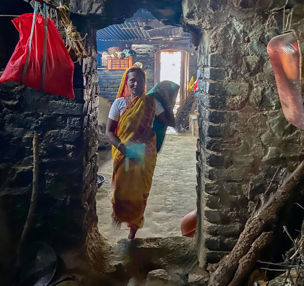 Kamala Bai, 60, (center) a farm worker, shares her two-room hut in Dharur village with her husband, mother-in-law, a daughter, two sons and their families. After nearly five decades working in sugarcane farms and factories, she now mobilizes workers in her community to demand better wages and dignified treatment.