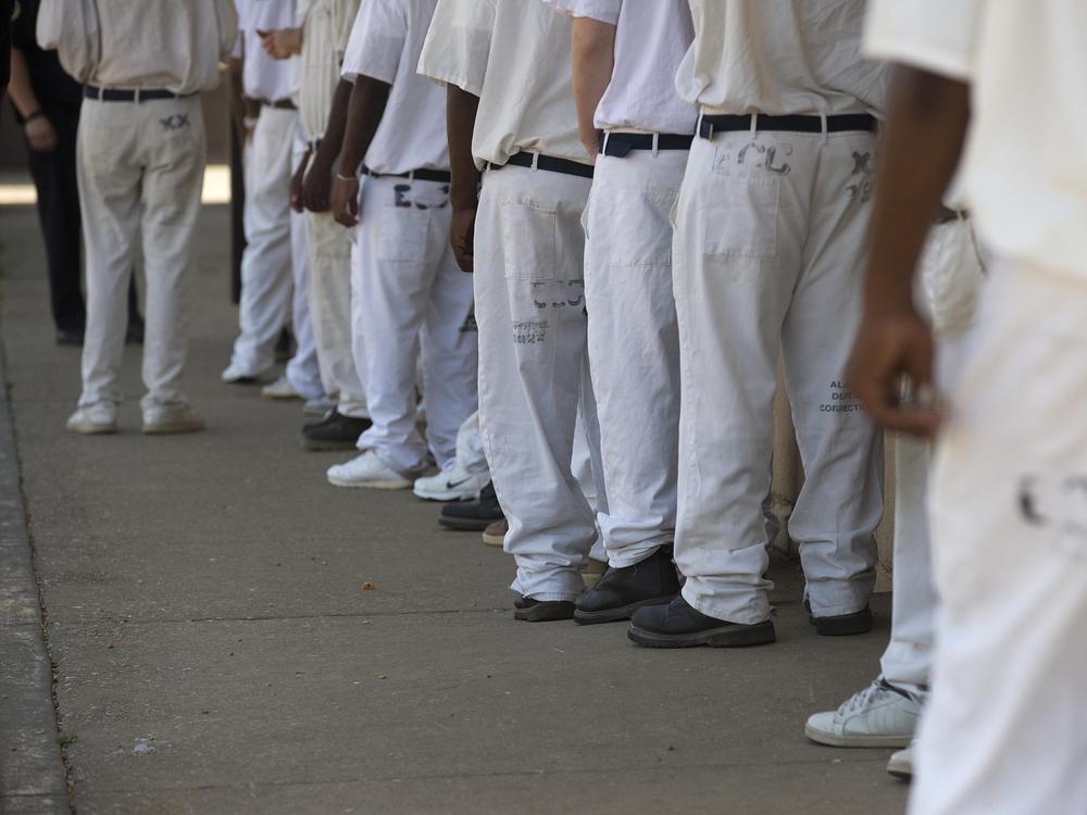 In this 2015 file photo, prisoners stand in a crowded lunch line at Elmore Correctional Facility in Elmore, Ala. In 2021, a federal judge who previously ruled mental health care in Alabama prisons was 