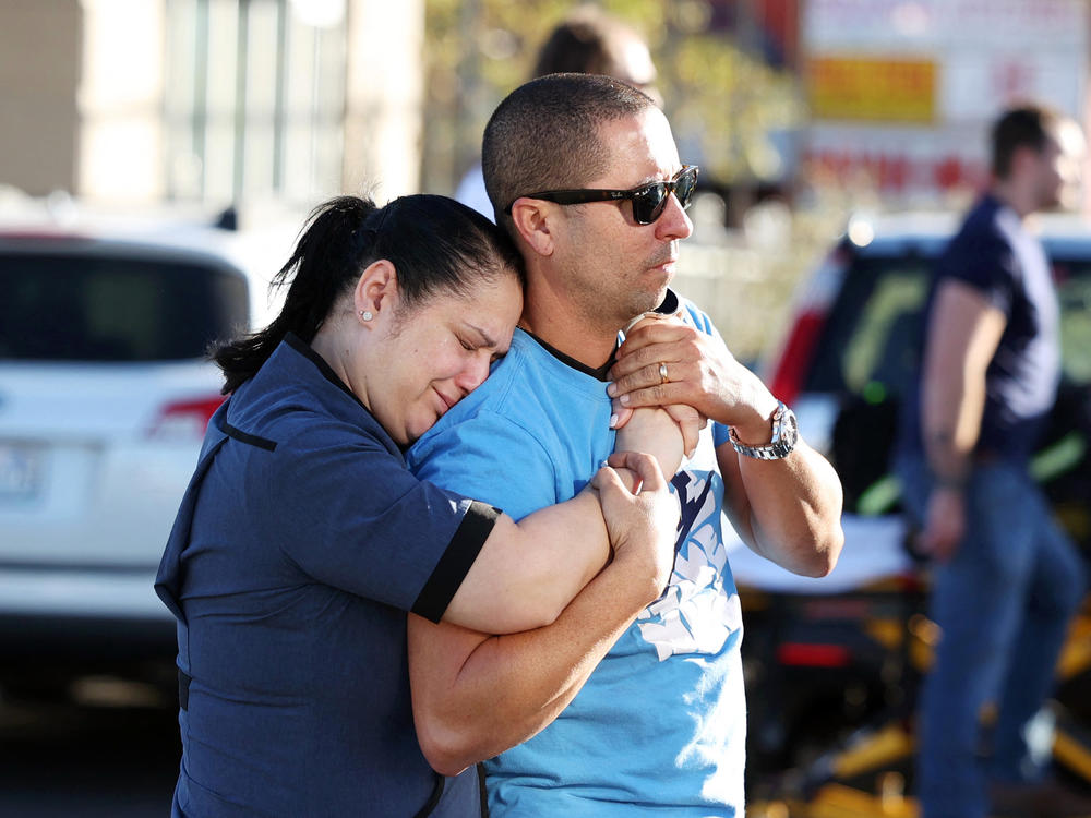 Parents Mabel Fontanilla and Raul Villalonga embrace following a shooting at the University of Nevada, Las Vegas, campus on Wednesday.