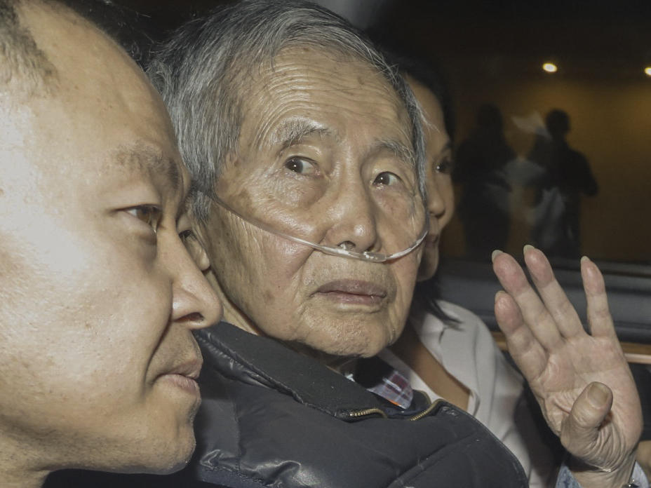Former Peruvian President Alberto Fujimori sits between his children Kenji (left) and Keiko upon his release from the Barbadillo prison in the eastern outskirts of Lima, on Wednesday.